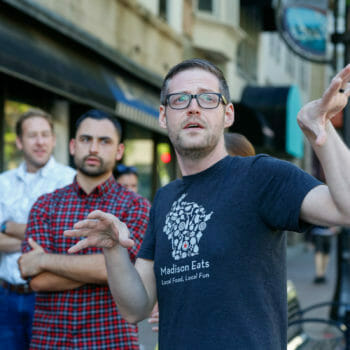 Guide with food and drink tour group on street