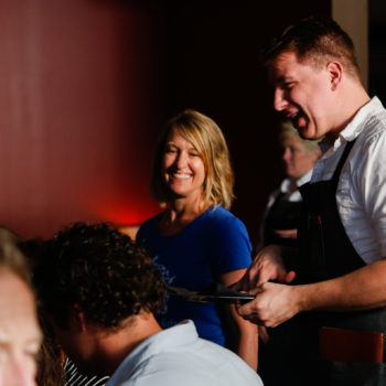 Food and Drink tour guide and restaurant worker chatting with guests