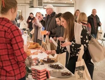 Artisan food tour group trying samples at long table