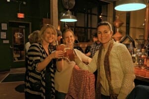 Guests toasting glasses at stop on food and drink tour