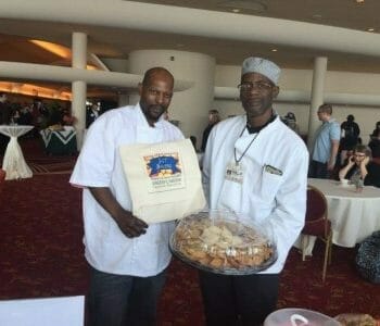 Two caterers holding tray of food at Monona Terrace event