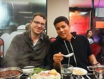 Two guests dining and smiling at Double 10 Mini Hot Pot