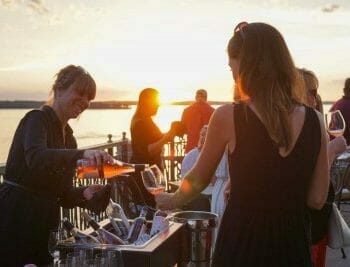 Serving pouring rose wine at sunset for guests