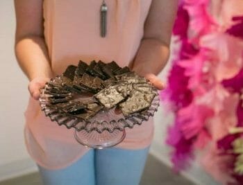 Woman holding platter of chocolate