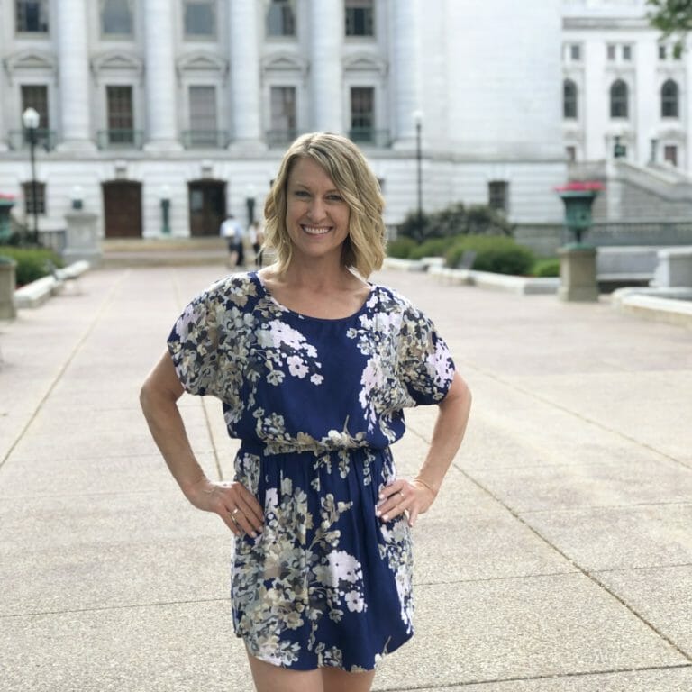 Otehlia Cassidy stands in front of the WI State Capitol.