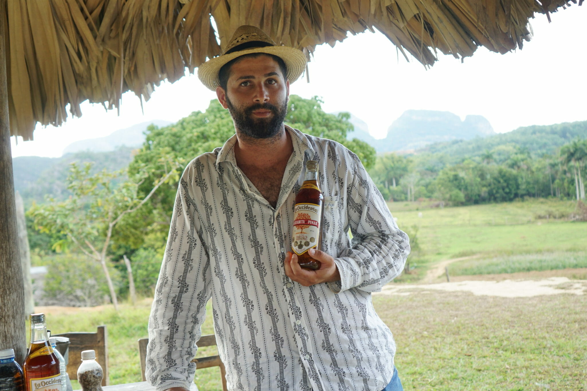 Farmer holds locally produced rum in Viñales, Cuba