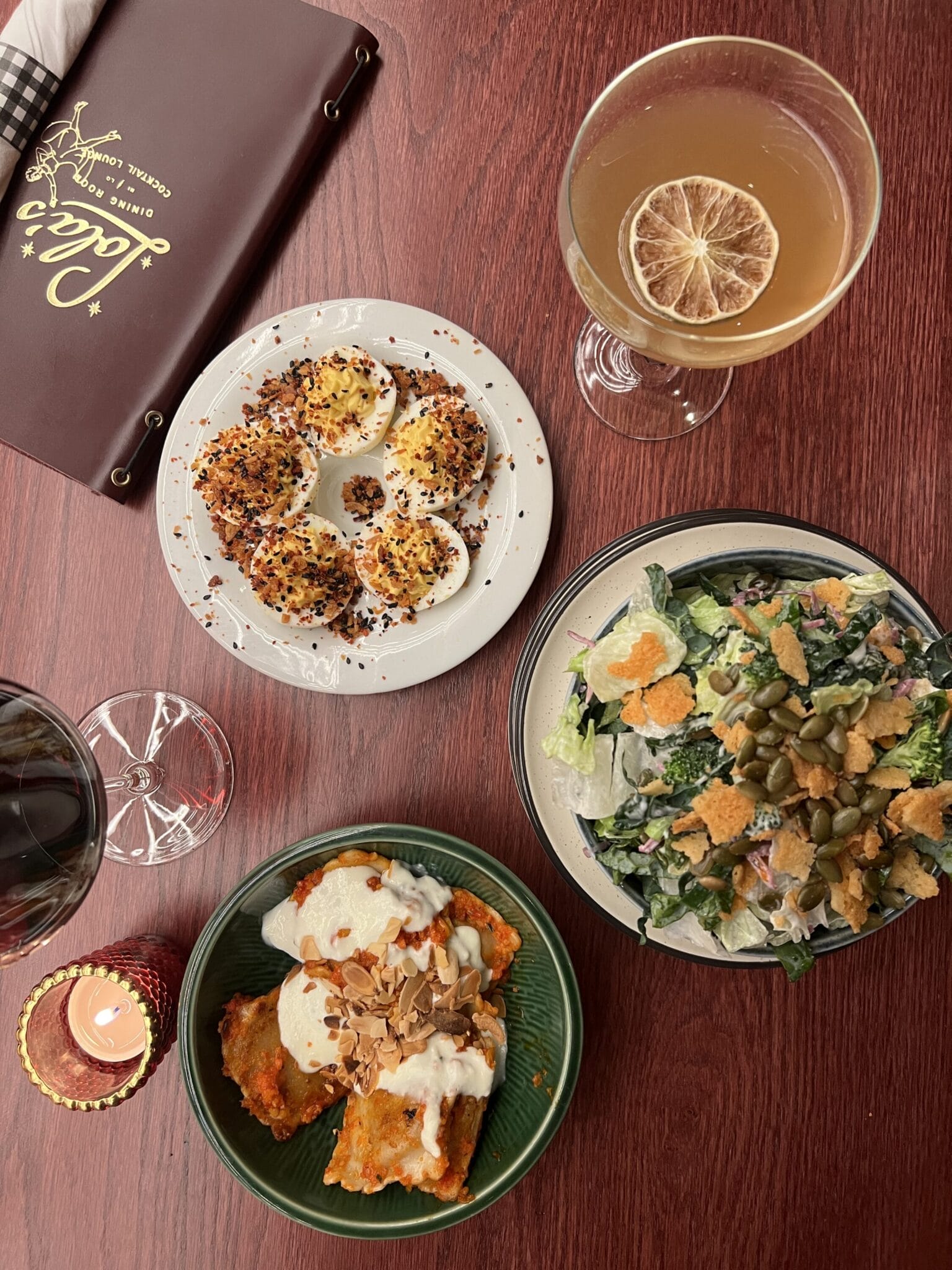 spread of food from Lola's - deviled eggs, chopped salad and cocktail