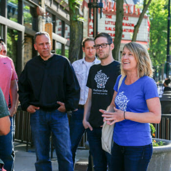 Guides with food and drink tour group on King Street in Madison, Wisconsin