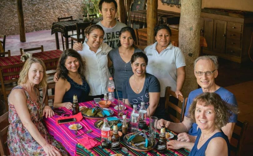 Guests posing with restaurant owners/workers