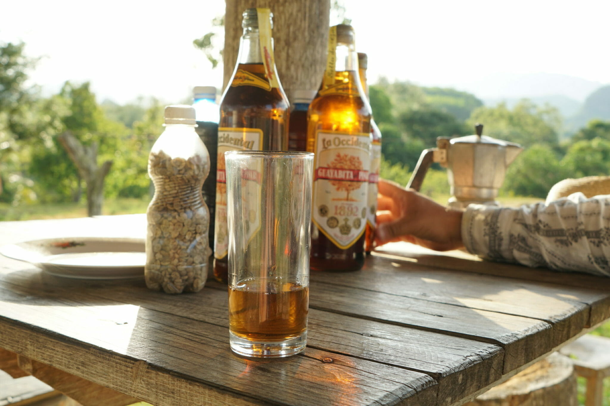 Bottles and glass of rum on table