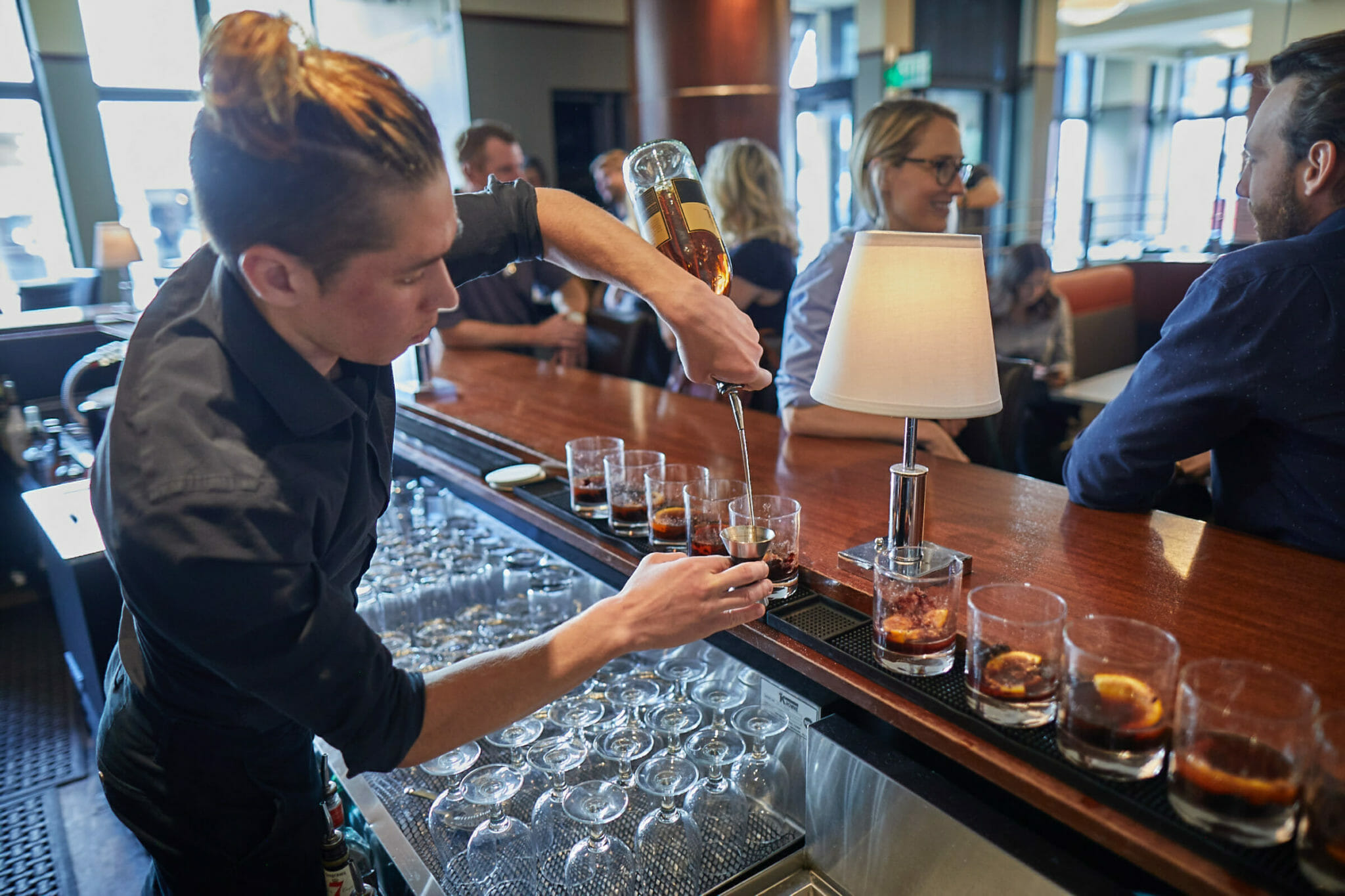 Bartender pouring drinks for Fare & Square food and drink tour