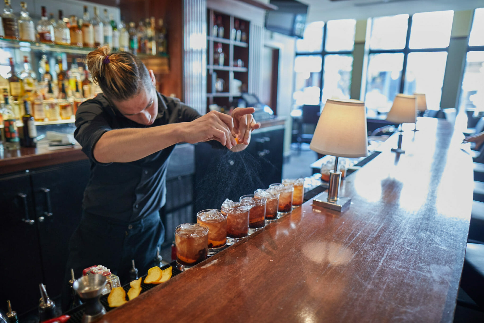 Bartender finishing cocktails for Fare & Square food and drink tour