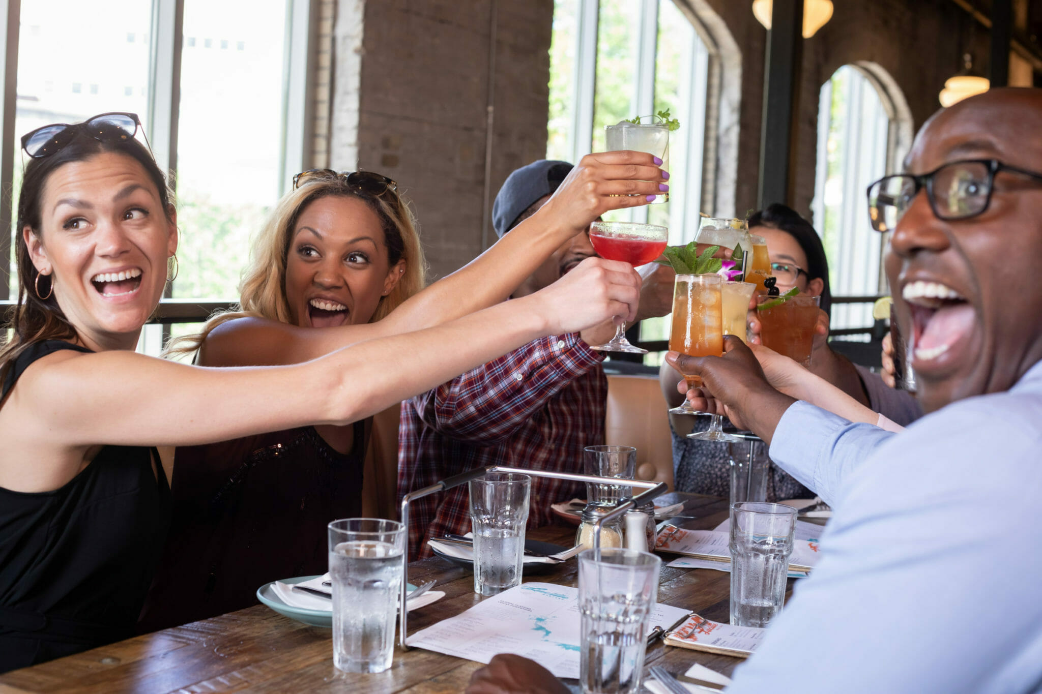 A diverse group enjoying food and drink